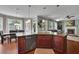 Open kitchen with stone countertops, wood cabinets, and a seamless flow to the living area at 4100 Secret Shoals Way, Buford, GA 30518