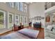 Inviting living room with tall windows, hardwood floors, stylish furniture, and an open layout at 4100 Secret Shoals Way, Buford, GA 30518