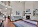 Spacious living room with high ceilings, fireplace, built-in shelving, hardwood floors, and natural light at 4100 Secret Shoals Way, Buford, GA 30518