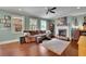 Warm living room featuring a fireplace, comfortable seating, and large windows for natural light at 4100 Secret Shoals Way, Buford, GA 30518
