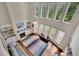 Open-concept living room featuring a fireplace, hardwood floors, large windows, and a view of the second-floor balcony at 4100 Secret Shoals Way, Buford, GA 30518