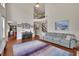 Bright living room with tall ceilings, hardwood floors, a comfortable sofa, and a view of the upstairs landing at 4100 Secret Shoals Way, Buford, GA 30518