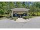 Community mailboxes in a shaded area with landscaping that adds convenience and aesthetic appeal at 4100 Secret Shoals Way, Buford, GA 30518