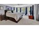 Spacious main bedroom featuring a ceiling fan, bay windows, and a king-sized bed with storage at 4100 Secret Shoals Way, Buford, GA 30518
