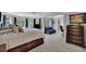 Spacious main bedroom with large windows, tray ceilings, and a comfortable sitting area at 4100 Secret Shoals Way, Buford, GA 30518