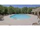 Community pool surrounded by lounge chairs providing residents with relaxation and recreation at 4100 Secret Shoals Way, Buford, GA 30518