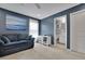 Room with blue walls featuring carpeted floors, a ceiling fan, and a view into the bathroom at 4100 Secret Shoals Way, Buford, GA 30518