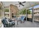 Inviting sunroom featuring a stone fireplace, comfortable seating, and screened windows for relaxation at 4100 Secret Shoals Way, Buford, GA 30518