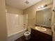 A bathroom with tile floors, combination tub and shower and a granite-look vanity at 4649 Camelot Dr, Douglasville, GA 30135