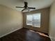 Bedroom featuring hardwood floors, natural light from a large window, and a ceiling fan at 4649 Camelot Dr, Douglasville, GA 30135