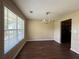 Dining room featuring hardwood floors, neutral colored walls, modern chandelier, and natural light at 4649 Camelot Dr, Douglasville, GA 30135