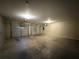 View of the two-car garage with dual garage doors and overhead lighting fixtures at 4649 Camelot Dr, Douglasville, GA 30135