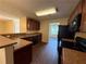 Kitchen with black appliances, wood cabinets and adjacent dining area with natural light at 4649 Camelot Dr, Douglasville, GA 30135
