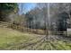 Fenced backyard surrounded by mature trees offers peace and privacy at 537 Autumn Ridge Dr, Canton, GA 30115