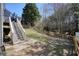 Spacious backyard with wooden fence and stairs leading to the back deck at 537 Autumn Ridge Dr, Canton, GA 30115