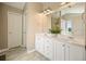 Well-lit bathroom with a large vanity, double sinks, and a plant at 537 Autumn Ridge Dr, Canton, GA 30115