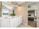 Bright bathroom with double sinks on white vanity, open to the main bedroom at 537 Autumn Ridge Dr, Canton, GA 30115