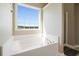 Bathroom with a soaking tub, large window, and separate shower at 537 Autumn Ridge Dr, Canton, GA 30115