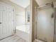 Bathroom with a tub, shower, and a door leading to the water closet at 537 Autumn Ridge Dr, Canton, GA 30115