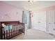 Bedroom with a crib, pastel walls, and closet at 537 Autumn Ridge Dr, Canton, GA 30115