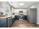 Modern kitchen featuring white cabinets, stainless steel appliances, and hardwood floors at 537 Autumn Ridge Dr, Canton, GA 30115