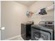 Bright laundry room with a modern washer and dryer, with shelving at 537 Autumn Ridge Dr, Canton, GA 30115