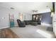 Comfortable living room featuring a plush sectional sofa and a gray accent wall at 537 Autumn Ridge Dr, Canton, GA 30115