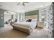 Spacious main bedroom featuring a tray ceiling, fan, and sitting area with a large bed and bench at 537 Autumn Ridge Dr, Canton, GA 30115