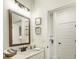 Bathroom features a vanity with decorative framed art, a large mirror, and modern lighting at 1846 Butterfly Way, Marietta, GA 30066