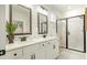 Bathroom featuring double sinks with black hardware and a glass walk-in shower at 1846 Butterfly Way, Marietta, GA 30066