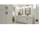 Bright bathroom featuring double sinks, glass shower, and built-in storage at 1846 Butterfly Way, Marietta, GA 30066