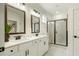 Elegant bathroom features double sinks, shaker cabinets, and a glass shower at 1846 Butterfly Way, Marietta, GA 30066