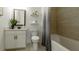 Well-lit bathroom with white vanity, tile floors, and a bathtub at 1846 Butterfly Way, Marietta, GA 30066