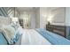 Light and bright bedroom with a light blue throw and coastal themed pillows at 1846 Butterfly Way, Marietta, GA 30066