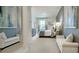 This bedroom features a grey-blue accent wall and white chaise lounges at 1846 Butterfly Way, Marietta, GA 30066
