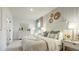 Bright, neutral bedroom features a decorative wall, white furniture and lots of natural light at 1846 Butterfly Way, Marietta, GA 30066