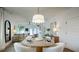 Open concept dining area with adjacent living room, table set for dinner, bright and airy at 1846 Butterfly Way, Marietta, GA 30066