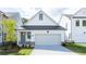 Charming, modern farmhouse with white siding, black roof, and attached garage, nestled on a well-manicured lawn at 1846 Butterfly Way, Marietta, GA 30066