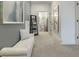 Hallway featuring a white tufted chaise lounge and view into the bathroom at 1846 Butterfly Way, Marietta, GA 30066