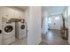 Hallway with laundry room access, wood floors, and natural light at 1846 Butterfly Way, Marietta, GA 30066