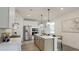 Bright kitchen features stainless appliances, island with seating, and modern lighting fixtures at 1846 Butterfly Way, Marietta, GA 30066