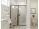 Bright bathroom featuring a glass shower with black trim and decorative ladder at 1846 Butterfly Way, Marietta, GA 30066