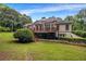 Expansive backyard with lush green lawn, mature trees, and a charming deck, perfect for outdoor living at 3018 Saint Andrews Ct, Jonesboro, GA 30236