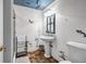 Bathroom features pedestal sink, unique fish decor, and wood-look tile flooring at 3018 Saint Andrews Ct, Jonesboro, GA 30236