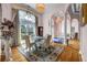 Formal dining room featuring hardwood floors, large windows, and elegant chandelier at 3018 Saint Andrews Ct, Jonesboro, GA 30236
