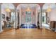 Elegant foyer with gleaming hardwood floors, decorative columns, and ornate chandeliers at 3018 Saint Andrews Ct, Jonesboro, GA 30236
