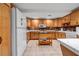 Kitchen features wood cabinets, white appliances, white countertops, and tile floors at 3018 Saint Andrews Ct, Jonesboro, GA 30236