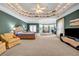 Expansive main bedroom with tray ceiling, sitting area, ceiling fans, and neutral carpet at 3018 Saint Andrews Ct, Jonesboro, GA 30236