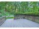 Spacious backyard featuring a fire pit area with seating and lush green landscaping at 507 Falls Way, Woodstock, GA 30188