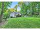 Beautifully landscaped backyard with fire pit and seating area for relaxing outdoors at 507 Falls Way, Woodstock, GA 30188
